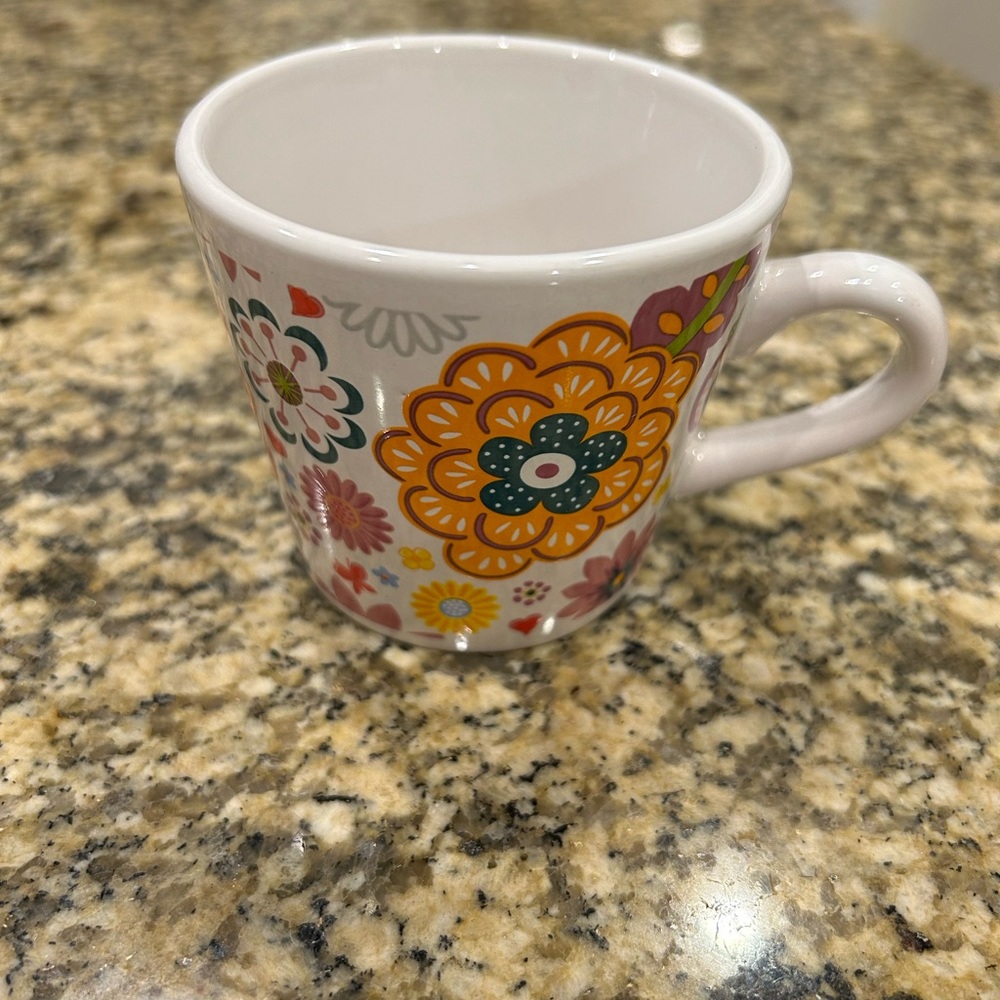 Floral tea or small coffee cups/mugs.